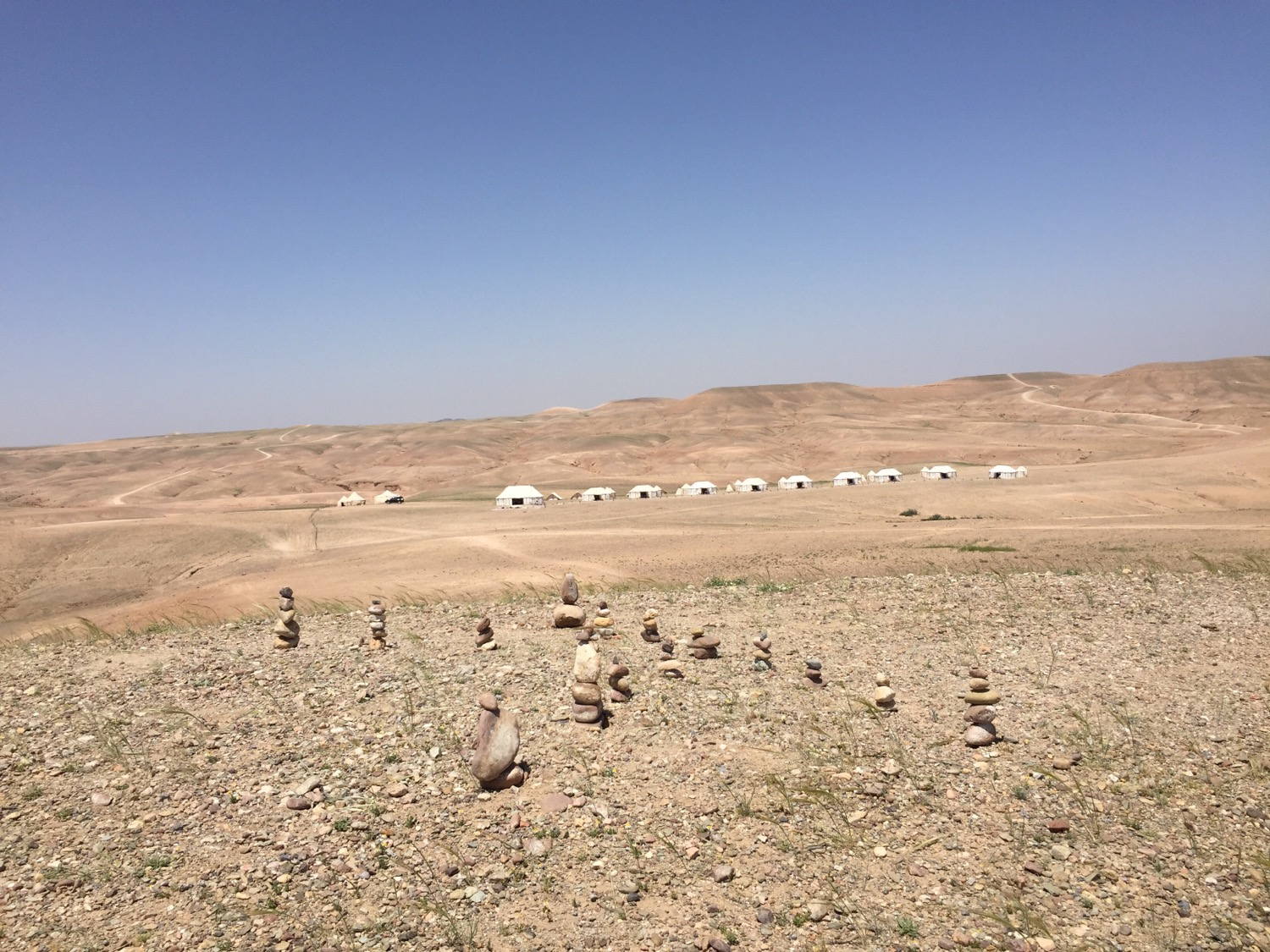 Relaxing in the desert. Building stone towers with the camp in the background.
