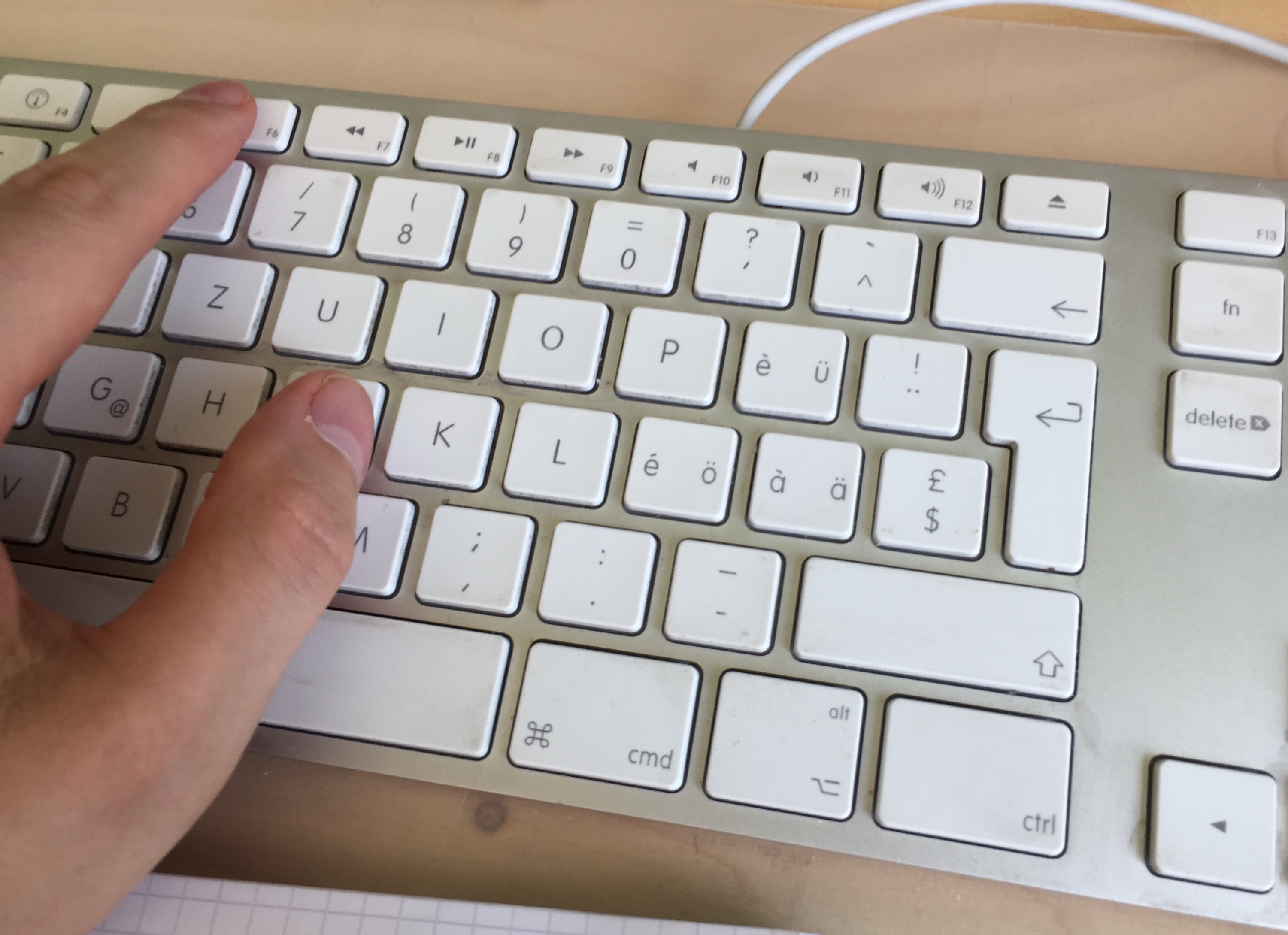 Keyboard with hand on F6 key