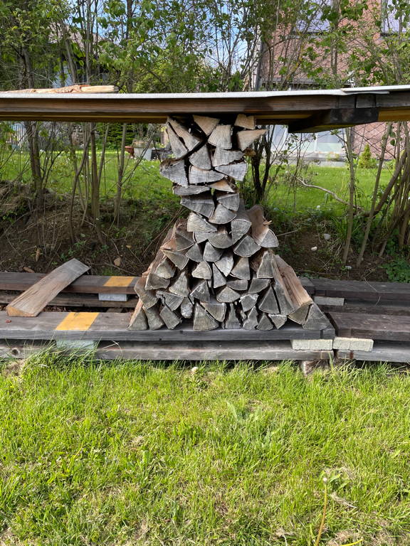 Pillar holding up the roof of the wood stack.
