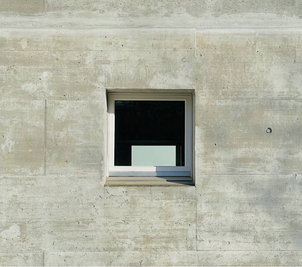 A window in a concrete wall. Where could it lead?
