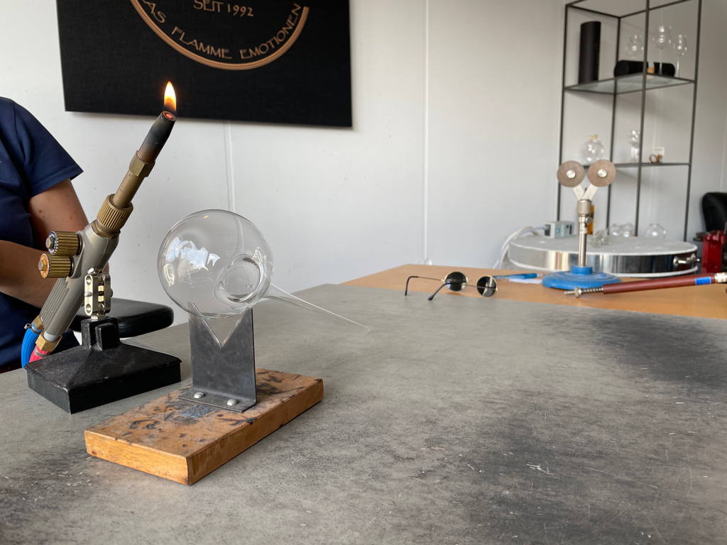 Part of a wine glass is just blew.
