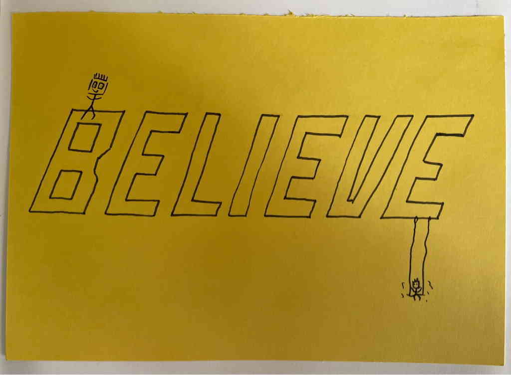 Believe text on yellow background. With two stick figures on it.
