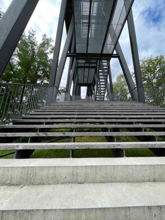 I picture of straws leading up onto an art installation. The stairs looks like they extend into heaven (due to the perspective of the photo).