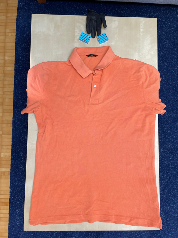 A closeup picture of an orange polo shirt.