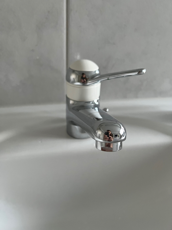 Close-up of water-tap. It is one with only a single lever which mixes warm and cold water as well as turns it on and off.