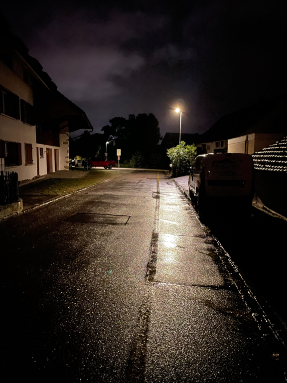 A rare road photographed during the early morning hours while it still was dark. A single street light gives some light to the scene.  