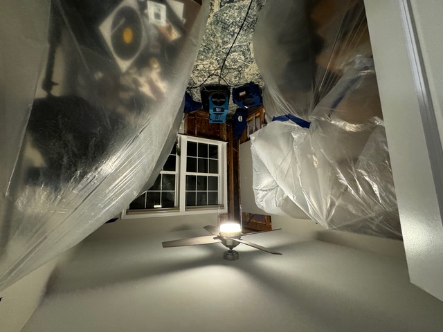 Jason's office all the furniture is coverd in plastic and part of the wall is broken open to dry out.