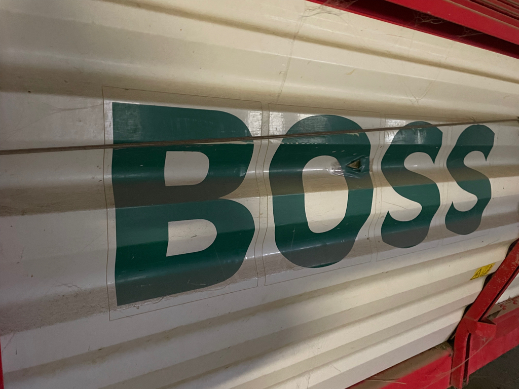 Closeup of the text “BOSS” on the side of a vehicle.