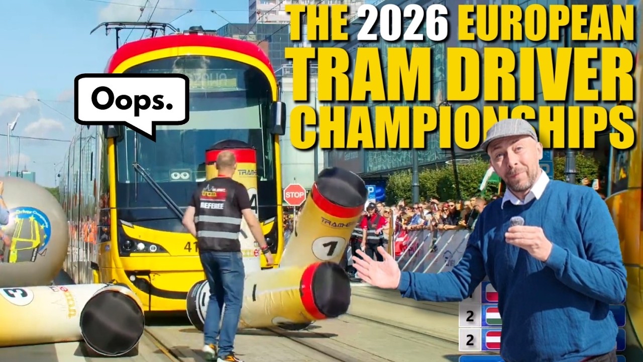 This YouTube video thumbnail shows a scene from the “2026 European Tram Driver Championships.” A yellow tram is on the tracks, and there’s a large inflatable obstacle with “Oops” in a speech bubble. A referee walks on the tracks, and a man in the foreground gestures toward the action, holding a microphone. A crowd watches in the background. Bold yellow text displays the event name at the top right.